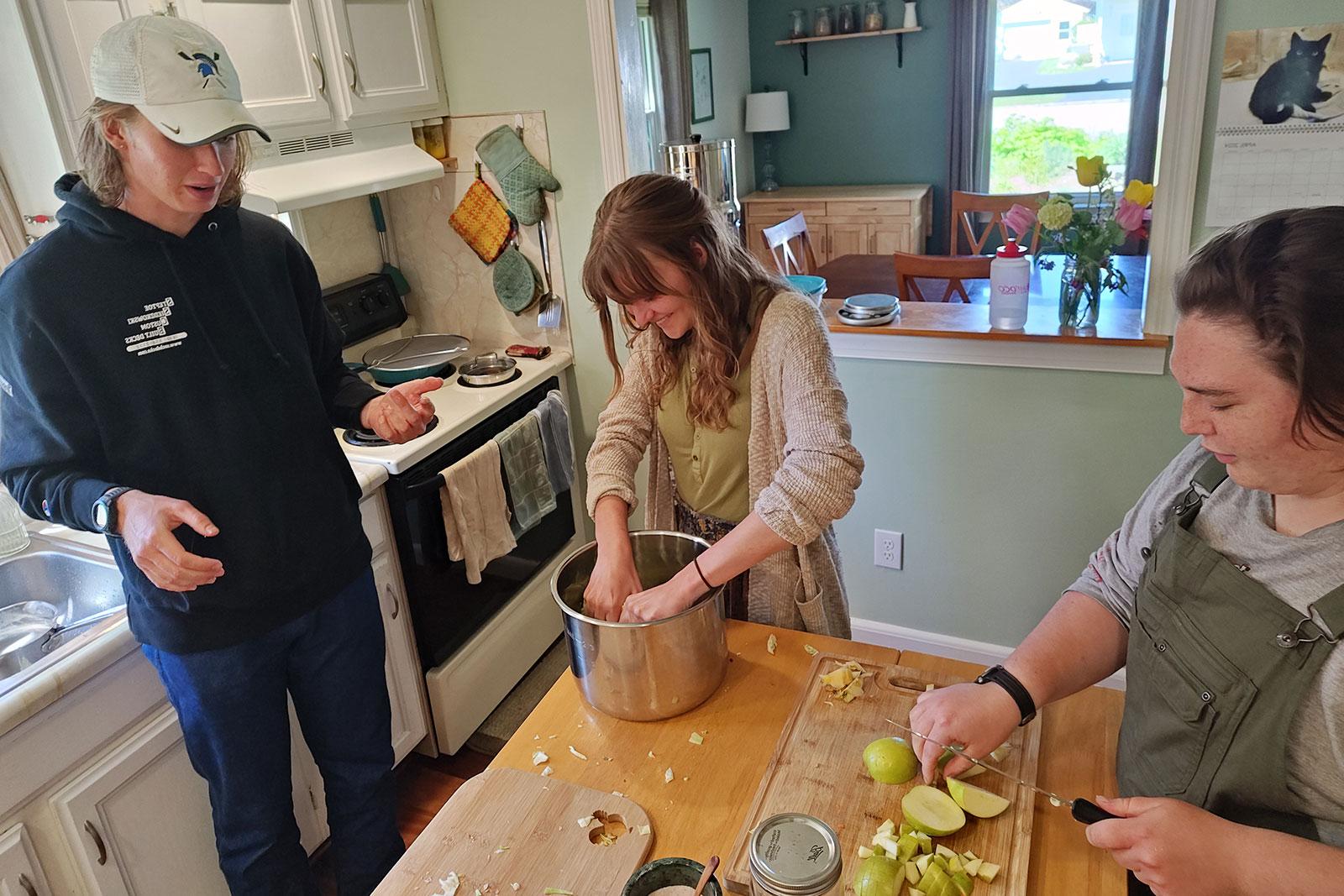 Permaculture Interns preparing food for the May Day Celebration