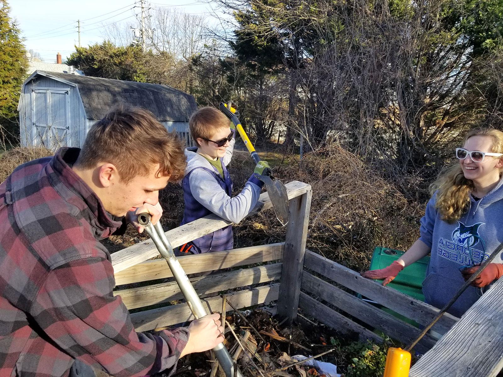 Students create a new 18-day compost pile at the campus garden.